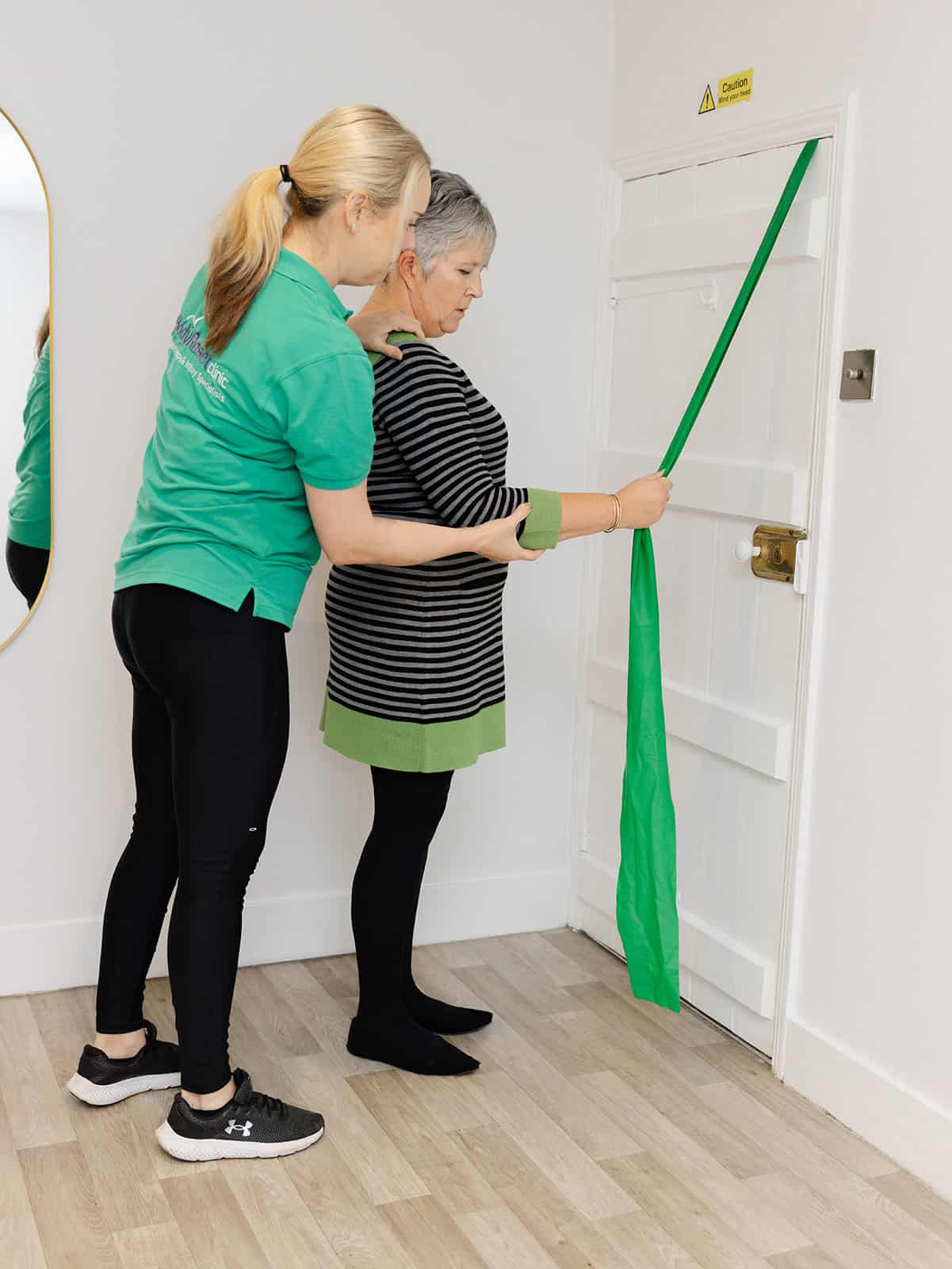 Improvement Body Reset staff member demonstrating a treatment exercise from a personalised plan 