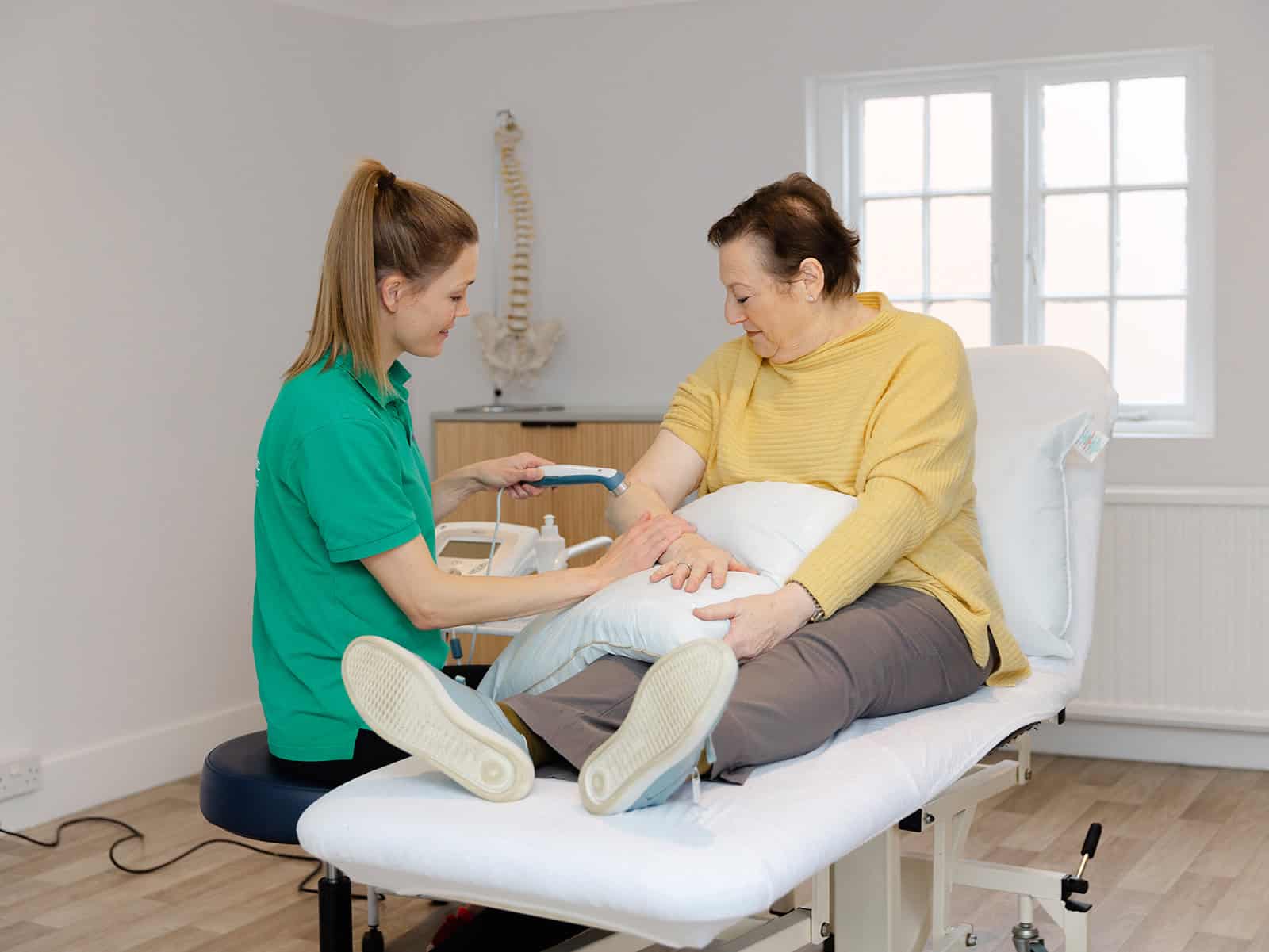 Close-up of shockwave therapy on client’s lower leg for targeted treatment 